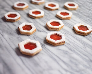 Strawberry Jam Linzer Cookies on White Marble