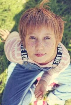 Outdoor portrait of 10 years old girl with glitter