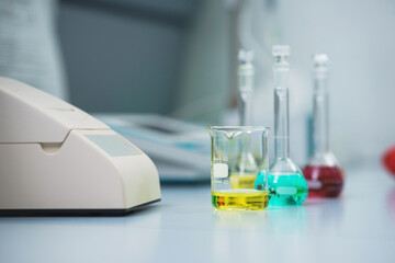 Test tubes and flasks with test liquid on the table in a chemical lab