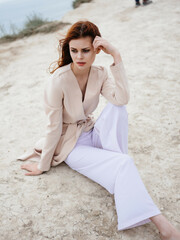 pretty woman posing near rocks in the sand model Travel