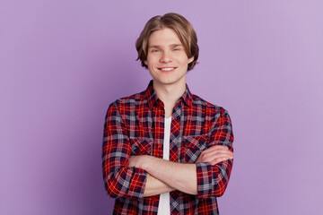 Portrait of self-assured cheerful cool guy folded hands look camera on purple background