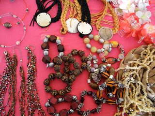 Fototapeta na wymiar Close up view of jewelry on red table at art market