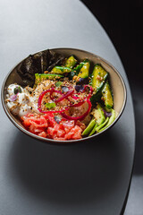 Mix of hawaiiajn Salmon and Tuna poke bowls in colorful bowls wi