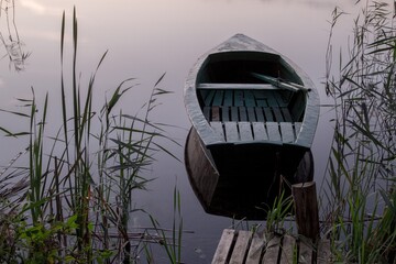 Small boat on a tranquil water of Rynskie lake (Jezioro Ryńskie) in Ryn, Poland. Masurian Lake...