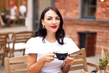 Beautiful woman drinking coffee in a cafe