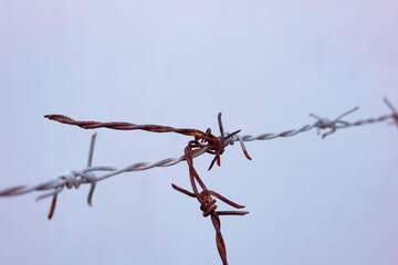 Old barbwire hanging in the air,rust and dirty