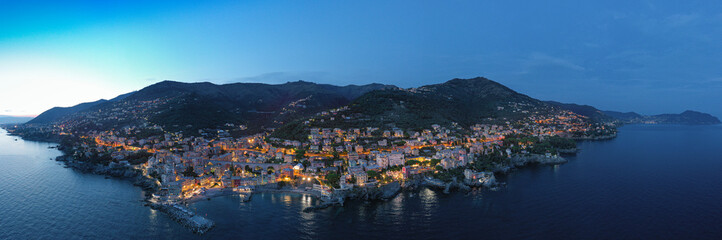 Fototapeta na wymiar Italy. The towns of Liguria. Night. City lights. Italy mediterranean coast. Aerial view.