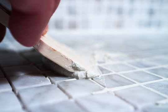 Image of the process of filling the seams of tiled mosaic.