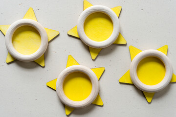 yellow stars and wooden rings on a speckled paper background