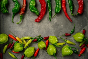 Different types of homegrown chillies or chilli peppers background, selective focus