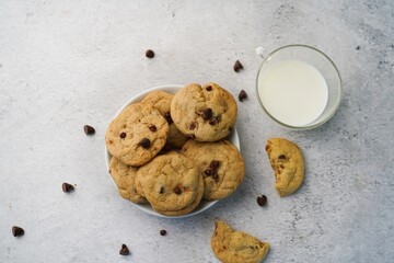 Homemade chocolate chip cookies served with milk, selective focus