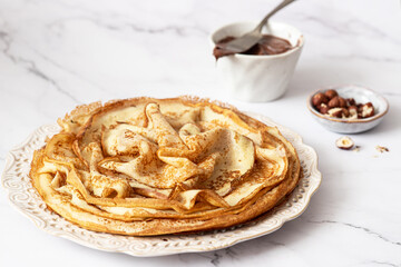 Homemade crepes, tasty thin pancakes with honey and tea