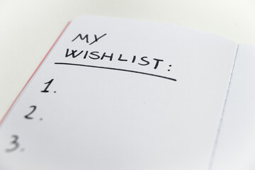 Notebook page marked 'my wishlist' in black ink on white paper. Goals and priorities of one's life. 
