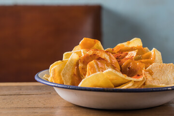 Delicious potato chips in bowl