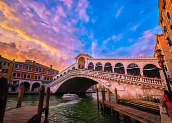 Fototapeta na wymiar Sunset view of famous bridge of Rialto or ponte di Rialto over Grand Canal, Venice, Italy. Iconic travel destination of UNESCO world heritage city