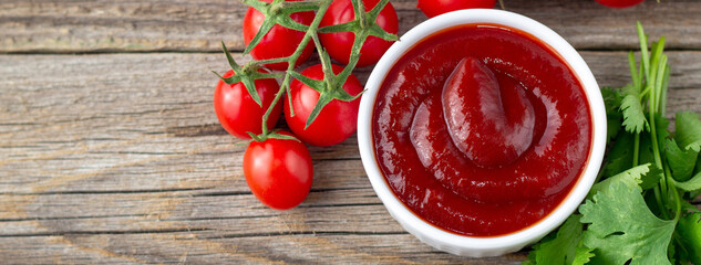 banner of White bowl of tomato sauce with parsley and tomato. Ketchup on natural wooden background