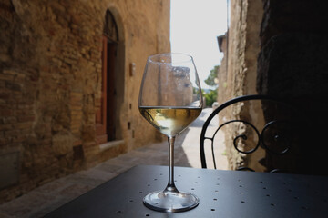 solated glass of wine, traditional italian aperetivo time on Tuscany, Italy cityscape background