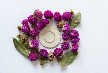 organic objects arranged around a silver ring on a  light background