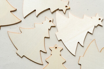 laser cut christmas tree ornament in thin plywood arranged on a paper background