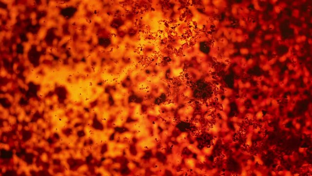 Dark orange crystals - thymol blue, only partially soluble in water - moving over liquid surface, closeup microscopy detail, abstract science background