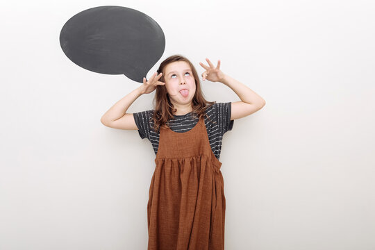 Photo of funny childish teenage girl make funky face stick tongue out isolated on white color background