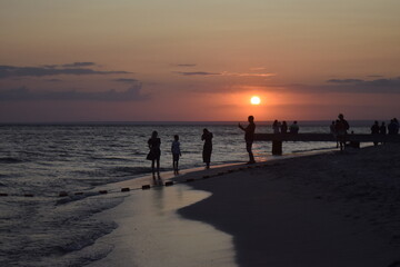 people walking on the beach