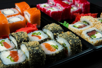 a variety of sushi close-up on a black background