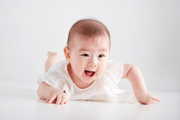 Closeup of cute Asian baby playing on the floor