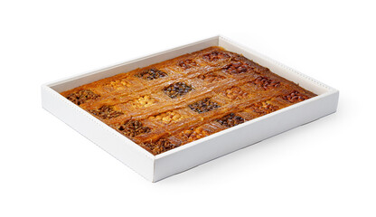 Assortment of Turkish baklava dessert in a white box isolated on white