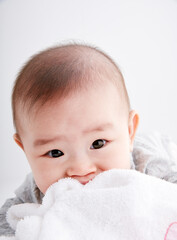 Close-up of cute Asian baby playing on the floor
