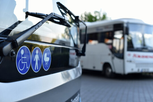 modern bus with sticker symbols of disabled person, an elderly person and a stroller with a baby
