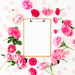 Blogger of freelancer composition with clipboard and pink roses on white background. Flat lay