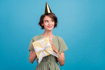 Photo of cute young brunette lady hold present wear khaki dress cap isolated on blue color background
