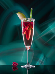 Fruit cocktail with blueberries and strawberries on colorful lights background