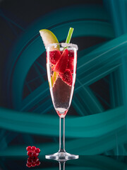 Fruit cocktail with blueberries and strawberries on colorful lights background