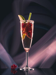 Fruit cocktail with blueberries and strawberries on colorful lights background