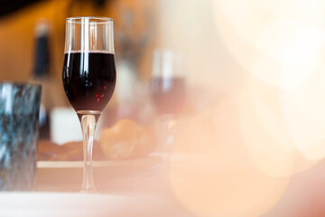Two glasses with red wine on wooden table