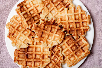 Belgian homemade cottage cheese waffles on a white plate.