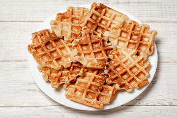 Belgian homemade waffles made from cottage cheese on a white plate.