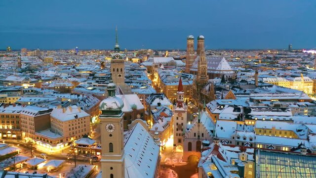 Aerial view of Munich City Germany at winter with snow, Cathedral Church of Our Lady (Frauenkirche) in munich old town Marienplatz. Munchen Skyline aerial view at morning. Munich night winter skyline.