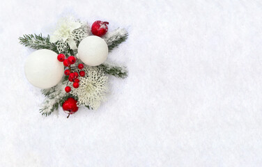 Naklejka na ściany i meble Christmas decoration. Twigs christmas tree, red berries, apple and white balls, white openwork poinsettia flowers on snow with space for text. Top view, flat lay