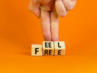 Feel free symbol. Businessman turns wooden cubes with concept words 'Feel free' on a beautiful...