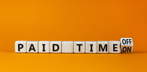 Paid time off or on symbol. Turned a wooden cube and changed words 'paid time on' to 'paid time...