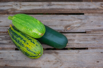 there are small colorful zucchini on the board