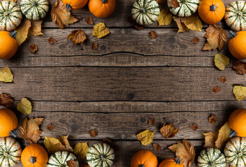 Autumn composition from pumpkins and autumn leaves on wooden background. Concept of Thanksgiving...