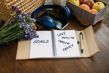 New Years Resolutions Goals motivational phrase in open notebook on the table. Outdoor still life...