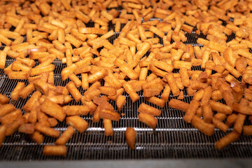 Process of making croutons. Cracker on conveyor. Bread products on conveyor line, in food factory or in factory with equipment