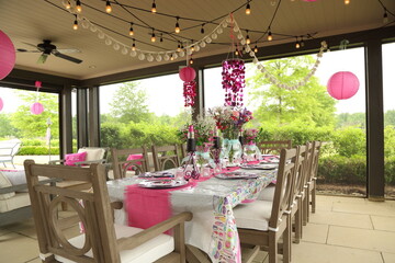 Decorated outdoor table scene at girl's lipstick-themed birthday party