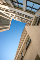 Facade of a  European building  with multi-layer architecture agsinst blue sky.