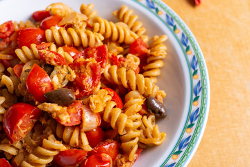 Pasta with cherry tomatoes, tuna fish and olives. Idea for mediterranean lunch.